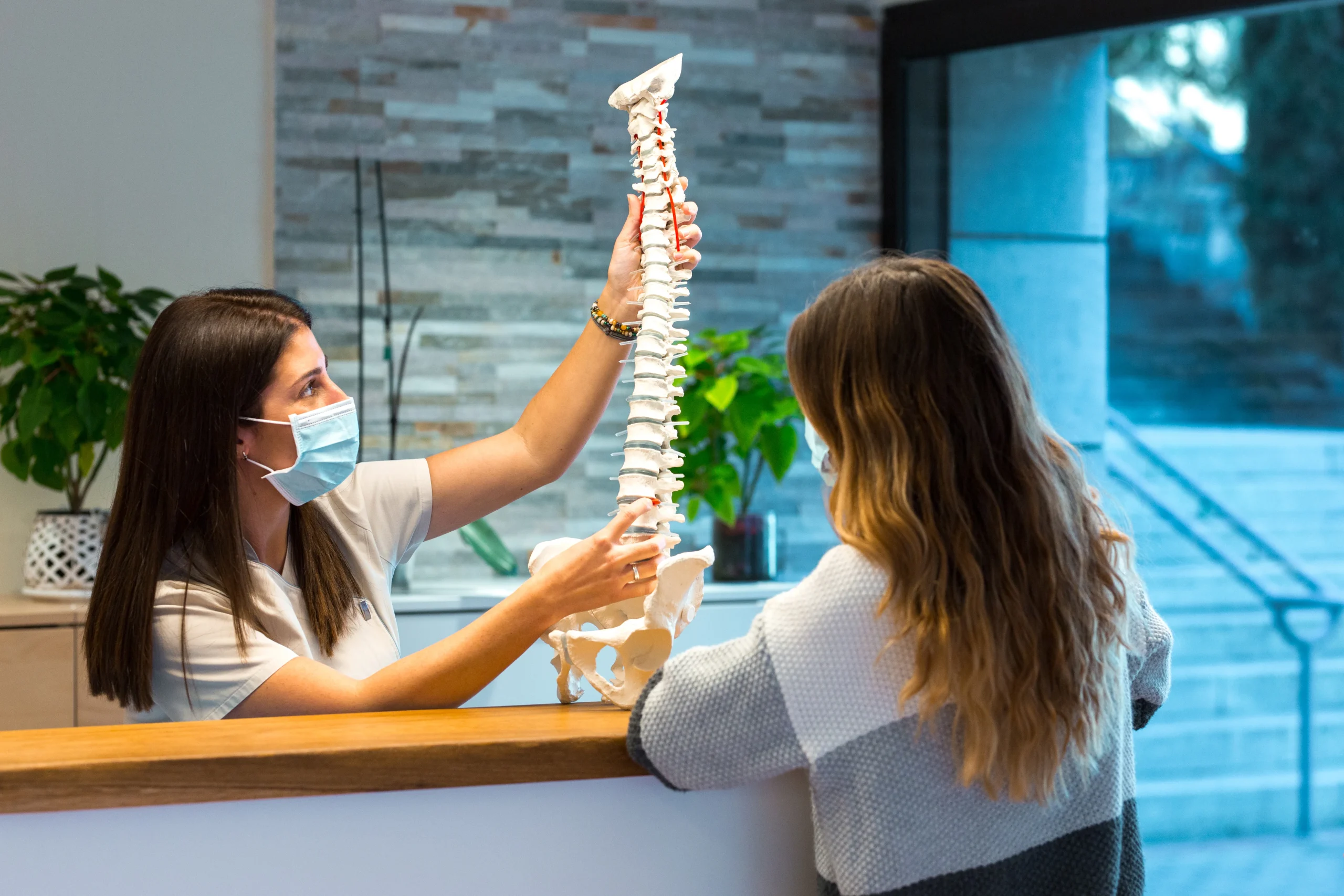 Chiropractor providing Chiropractic Adjustments Calgary treatment to a patient